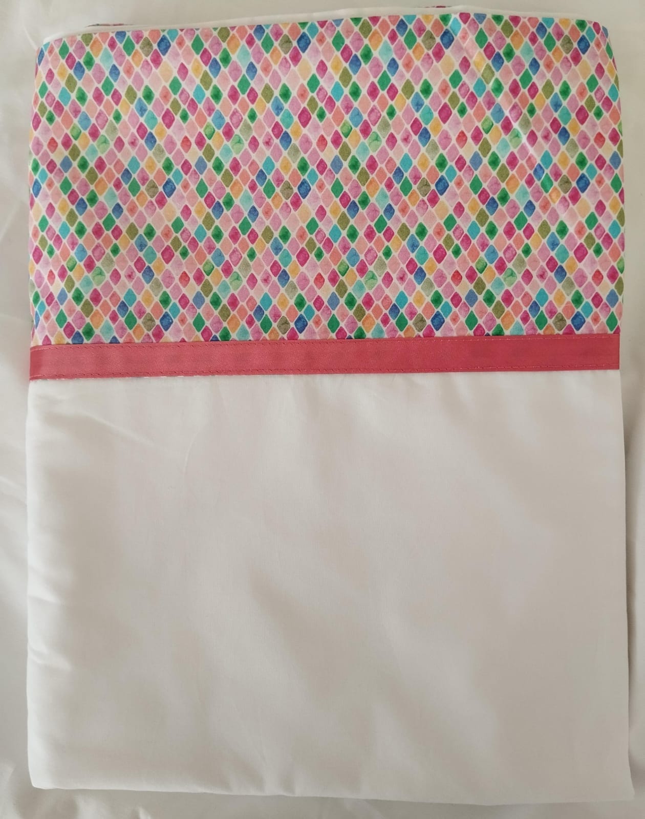 Tela con estampado rombos de colores y cinta fucsia
